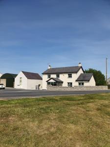 a white house on the side of a road at The Aul Shop & Public House -entire private annexe 