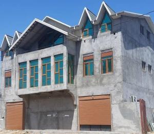 a building with a bunch of windows on it at Hostel One in Lankaran