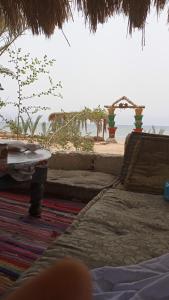 a bedroom with a bed and a view of the beach at sababa village in Nuweiba