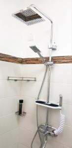 a shower with a metal shelf in a bathroom at La Marquise Résidences in Flic-en-Flac +15 photos