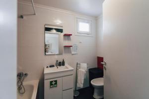 Un baño blanco con lavabo e inodoro. en Quintas do Mar, en Ribeira Grande 25 fotos más