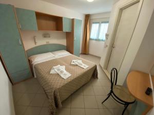 Posteľ alebo postele v izbe v ubytovaní Hotel Nanni Garnì