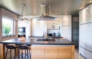 a kitchen with a island with a counter top at casa tibella in Ichtegem