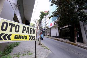 a sign on the side of a street with a motor scootercyclescycles at Nişantaşı Diamond Hotel in Istanbul