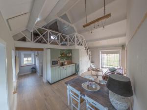 a kitchen and living room with a table and chairs at B&B Hoeve Klein Haneveld in Sint-Oedenrode