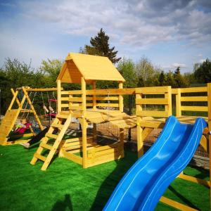 a playground with a slide and a play structure at Apartamenty Stołowe in Kudowa-Zdrój