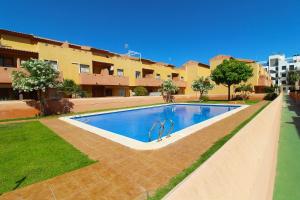 a swimming pool in front of a building at Nice 3 bedroom Duplex Cabo Roig in Orihuela Costa +31 photos