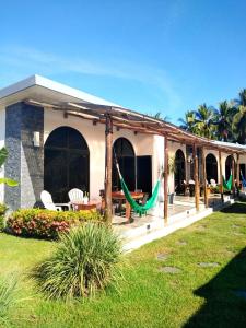 uma casa com um alpendre com redes de descanso no quintal em Show Pony Beach Resort and Suites em Las Lajas