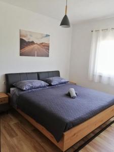 a bedroom with a bed in a room with a window at Modern penthouse Ivan with rooftop swimming pool and jacuzzi in Drinovci +37 photos