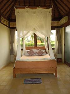 Postelja oz. postelje v sobi nastanitve Taman Bintang Villa Ubud