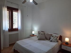a bedroom with a white bed and a window at Villa con piscina TERRAZZA DAL PICCIOTTO in Marsala +23 photos