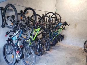 a bunch of bikes are lined up against a wall at Logis Le Cours in Saint-Gilles