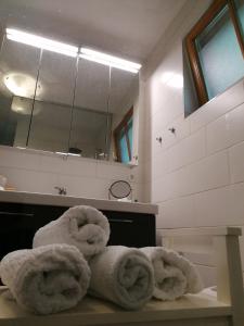 a bathroom with towels on a table in front of a mirror at Blumenhof Floraswelten in Altenwörth