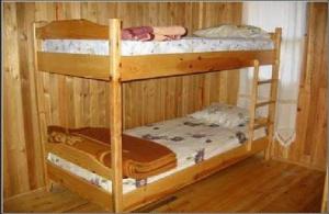 a couple of bunk beds in a wooden room at Bayrams Tree Houses in Olympos