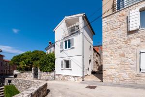 a white house with a balcony on the side of a building at Casa Bellavista Sea View in Rovinj