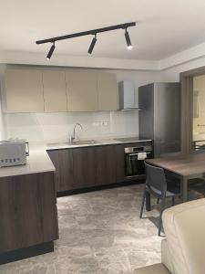 a kitchen with a table and a counter top at Sir William Strand in Il-Gżira
