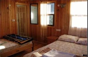a bedroom with two beds in a wooden room at Bayrams Tree Houses in Olympos