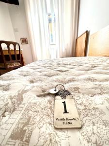 a white bed with a price tag on it at Piccolo Hotel Etruria in Siena