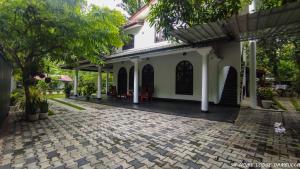 a house with a brick driveway in front of it at 98 Home Lodge Dambulla in Dambulla
