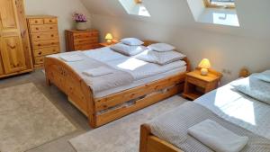 a bedroom with two beds and two night stands at Zichy Ház in Keszthely