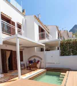 a villa with a swimming pool and a house at Anemos Suites Macari - San Vito Lo Capo in Macari