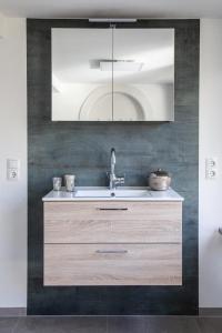 a bathroom with a sink and a mirror at Ferienwohnung Viventum34 in Vallendar