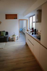 a kitchen and living room with a couch and a table at Ferienwohnung Viventum34 in Vallendar