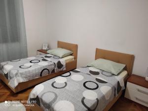 two beds sitting next to each other in a room at Apartment Adriana in Makarska