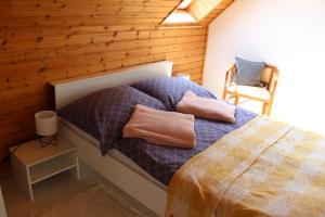 A bed or beds in a room at Napsugár Vendégház