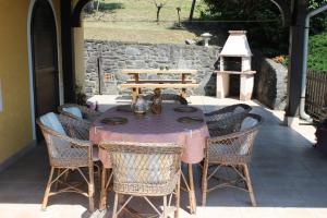 a table and chairs sitting on a patio at Napsugár Vendégház in Badacsonytördemic