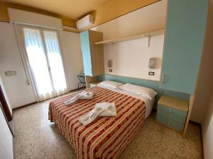 Posteľ alebo postele v izbe v ubytovaní Hotel Nanni Garnì
