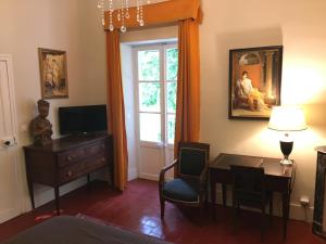 a living room with a table and a window at Domaine de Saint Charles in Les Plans