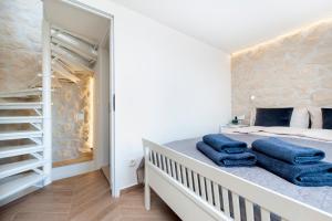 a bedroom with a bed with blue towels on it at Casa Bellavista Sea View in Rovinj