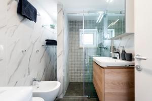a bathroom with a shower and a sink and a toilet at Casa Bellavista Sea View in Rovinj +11 photos