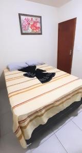 a bed sitting in a room with at Apto Aeroporto Vilage in Macaé