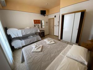 Posteľ alebo postele v izbe v ubytovaní Hotel Nanni Garnì