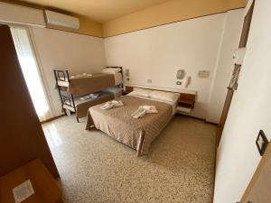 Posteľ alebo postele v izbe v ubytovaní Hotel Nanni Garnì