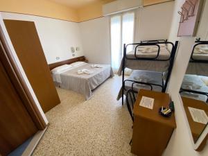 Posteľ alebo postele v izbe v ubytovaní Hotel Nanni Garnì