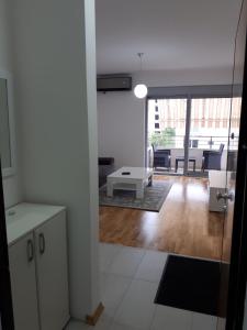 a kitchen and living room with a view of a living room at Apartman A3 in Ulcinj