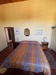 a bedroom with a bed and a dresser at Villa di Corliano Relais all'Ussero in San Giuliano Terme