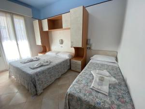 Posteľ alebo postele v izbe v ubytovaní Hotel Nanni Garnì