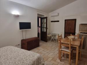 a bedroom with a bed and a table and a television at Alloggio Turistico Gasparrini in Bevagna