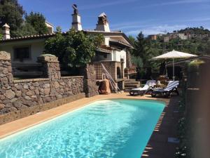 a swimming pool in front of a house at Casa Bados in Dorgali
