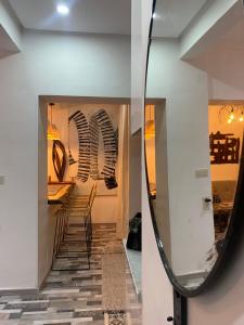 a mirror in a room with a table and chairs at Bel Appart Cosy plein coeur de Tanger vue mer in Tangier