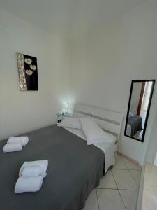 a bedroom with a bed with two towels on it at Appartamenti Le Castella in Le Castella