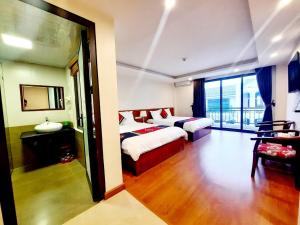 a hotel room with two beds and a large window at Sapa Star Hotel in Sapa