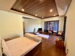 a bedroom with a bed and a living room at Niri-la Guest house Leh in Leh