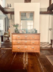 a wooden dresser in a room with a mirror at Casa Livia in Lindau