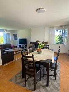 a living room with a table with chairs and a couch at Le coteau in Le Palais