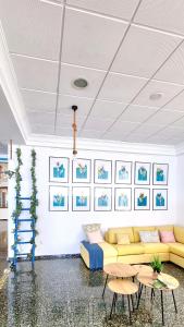 a living room with a yellow couch and tables at Hotel Altaia in Altea